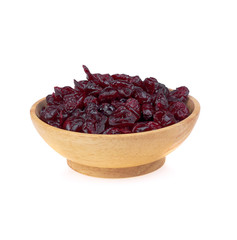 dried cranberries on wooden bowl isolate on white