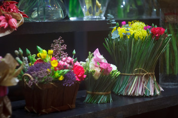 Flower shop concept, showcase with bouquets and flower vases for sale, selective focus