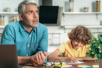 Obraz premium Father making school homework together with little kid