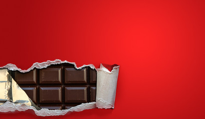 Dark chocolate bars in a red package strip open