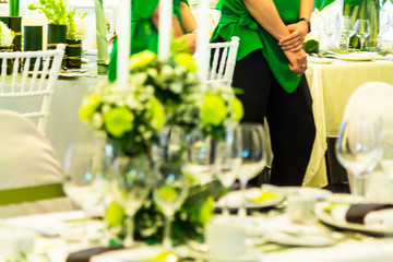 Waiter ready to service at Thanksgiving party dinner in restaurant.
