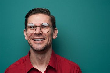 Portrait of a positive young man in glasses