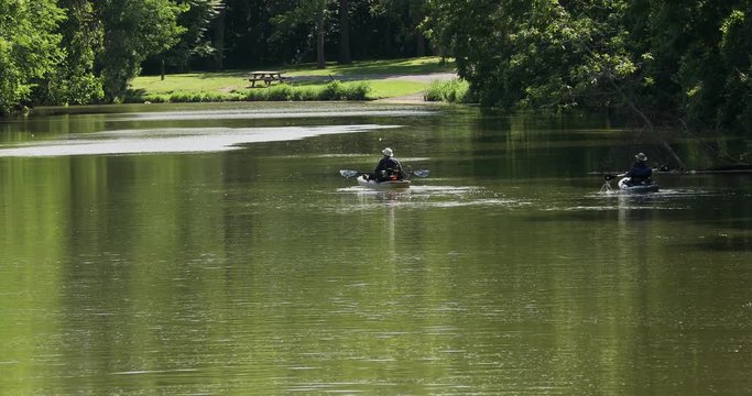 Erie Canal fishing from kayak on smooth water. Pioneer engineering wonder. 363 miles long man made waterway built in 1817. Transport of cargo from eastern ports and cities.