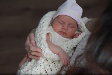 Baby newborn sleeping wrapped up in a blanket