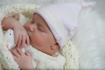 Baby newborn sleeping wrapped up in a blanket
