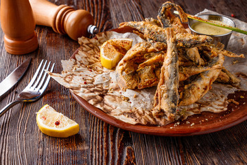 Set with seafood, small deep fried sea fish, food that is usually served with beer, horizontal orientation