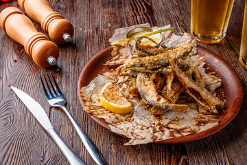 Set with seafood, small deep fried sea fish, food that is usually served with beer, horizontal orientation