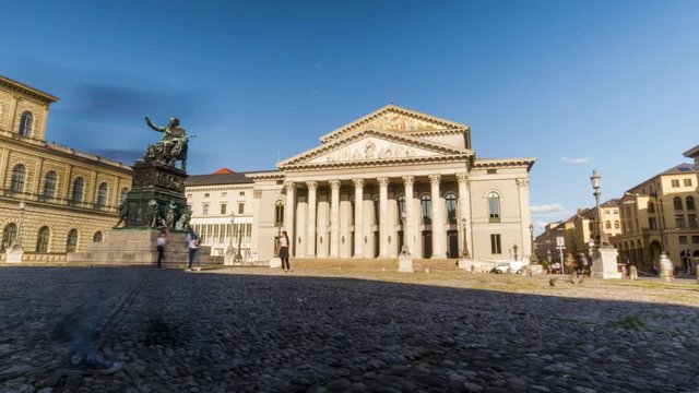 Munich 2019. Time Lapse of tourists passing in front of the Bavarian National Theater located on Max-Joseph-Platz. We are in the afternoon of a warm and sunny summer day. August 2019 in Munich.