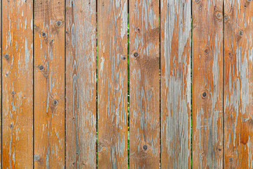 Obraz premium Close-up of a brown vertical wooden wall painted a very long time and the paint peeled off. Brown texture background