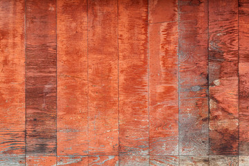Close-up of a  brown vertical wooden  wall  painted a very long time and the paint peeled off.  Brown texture background