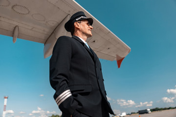 Adult man in uniform waiting for flight in airport