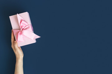 Woman holding present or gift box in her hands