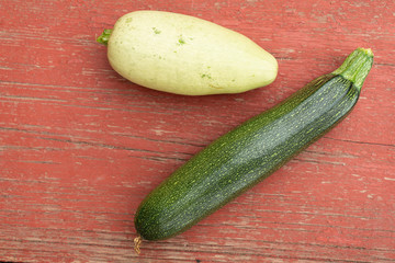 Homegrown green zucchini on old red vintage table