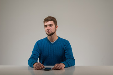 Sad young man at the table