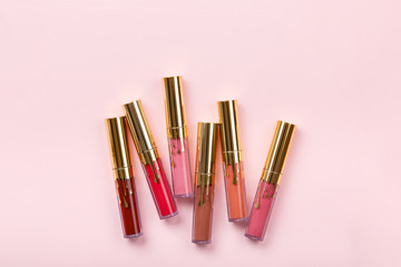 set of lipstick, lip gloss on pink background. Woman's cosmetics. Women's morning secrets....