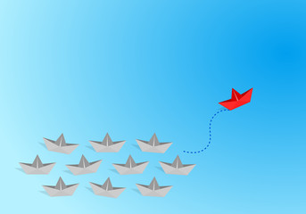 Red origami paper boat leading gray staff ones go on the route on blue background. Leadership and teamwork concept.