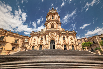 Fototapeta na wymiar Scenic entrance stairway and facade of the baroque cathedral of Modica, Sicily Italy.