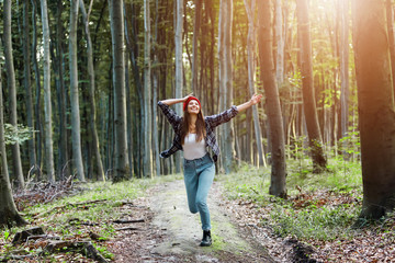 Naklejka na ściany i meble Freedom happy woman feeling alive and free in nature breathing clean and fresh air at the forest