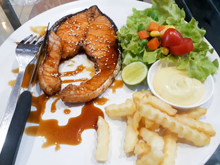 steak with salad, salmon steak, crispy grilled salmon steak with salad, Salmon fish steak grilled and fresh vegetable salad with tomato and lettuce. Healthy food. Top view
