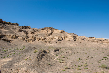 Rock in the sand in the sunlight