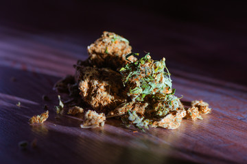 Close up of medical marijuana buds on wooden background