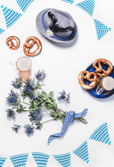 Modern Oktoberfest background with traditional Bavarian white blue fabric , decoration, pretzel ,...