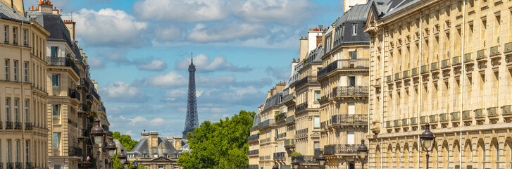 Eiffel tower between Parisian tenement old street alley and buildings - obrazy, fototapety, plakaty