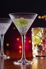 several cocktails on a bar in a cozy environment