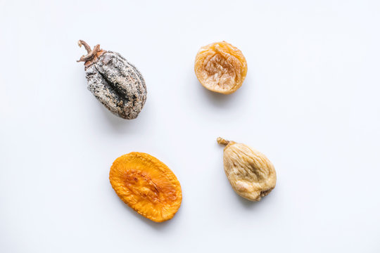 dried fruits lie on a white background, all kinds, rice, dried apricots, peach and grusha.Copy space