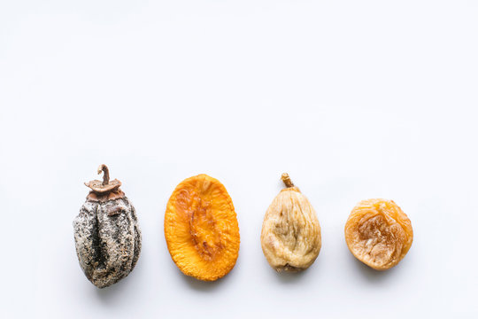dried fruits lie on a white background, all kinds, rice, dried apricots, peach and grusha.Copy space
