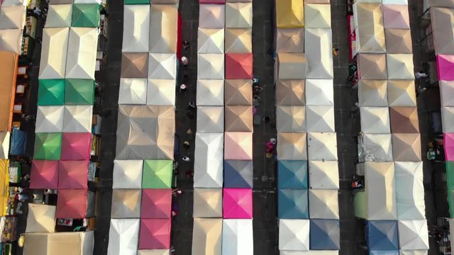 Rows of colorful tents seen from above, Ratchada Rot Fai Night Market aerial drone view.
