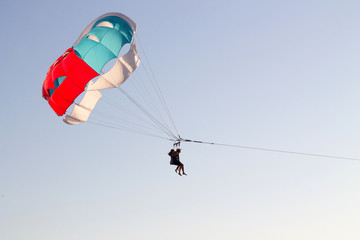 paragliding in the sky over the blue sea