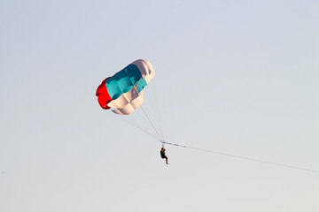 paragliding in the sky over the blue sea