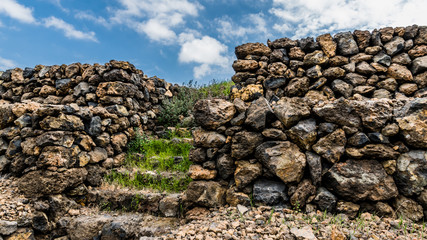 The steps of the stone pyramid are overgrown with grass