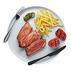 Delicious medium rare steak with French fries, pickled cucumber and grilled cherry tomatoes on a plate. Classic meat meal isolated on white background. Top view, directly above.