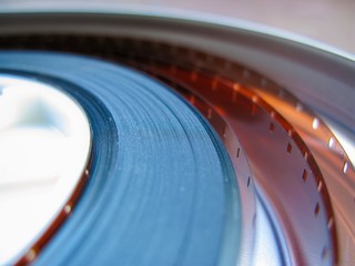 Roll of developed Super 16mm Film Negative on a Bobby in a can. 16mm Film is a popular and economical gauge of film stock