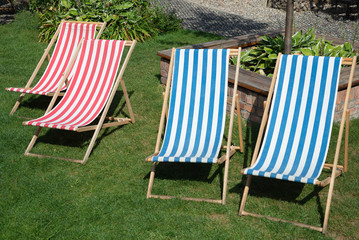 Deckchair chaise chair in caf&eacute; garden park gras, with blue red stripes relax
