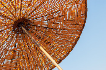 Bamboo beach umbrella with blue sky. Pattern close up