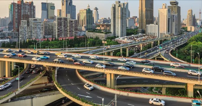 Time lapse of freeway busy city rush hour heavy traffic jam highway Shanghai,Yan'an East Road Overpass interchange,urban morden building.
