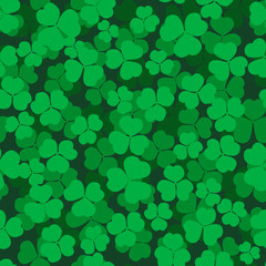 Decorative seamless pattern with shamrock. Endless floral ornament with clover on dark backdrop. Trefoil background. St.Patrick 's Day pattern