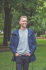 young man with a beard in a Park among the trees