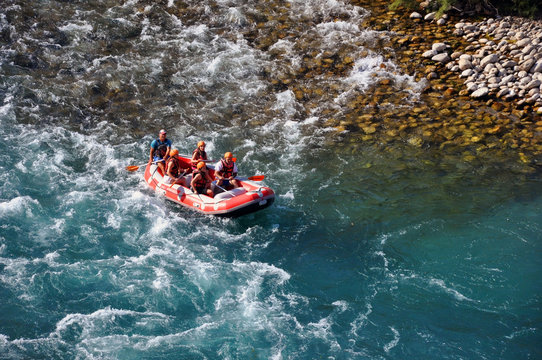 Alanya / Turkey - August 18, 2019: Rafting, a group of young people with a guide rafting along a mountain river. Extreme and fun sport at a tourist attraction.