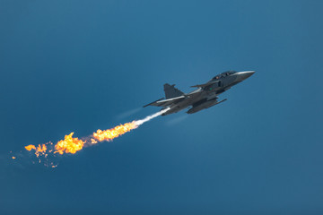 Jet fighter in the sky with fire flame