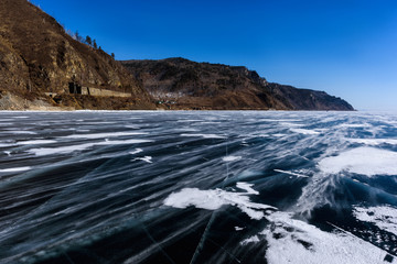 Frozen Lake Baikal. Beautiful mountain near the ice surface on a frosty day. Natural background