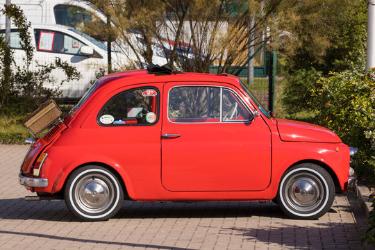 Stade, Germany - August 22, 2019: A  red vintage FIAT 500 or Cinquecento in a parking lot.
