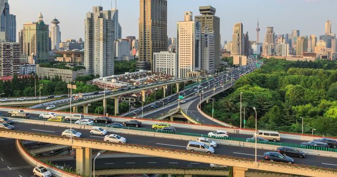 Time lapse of freeway busy city rush hour heavy traffic jam highway Shanghai,Yan'an East Road Overpass interchange,urban morden building.