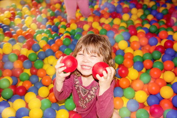 Fototapeta na wymiar beautiful child playing in a ball pool