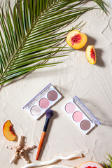 Vacation. A sculpting palette and brush lie on the beach sand, surrounded by vibrant fruits,...
