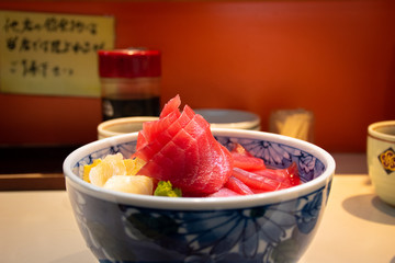 Tuna don with a bowl of rice, fresh sashimi