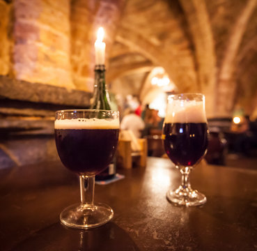 Two glasses of craft beer in a typical belgian pub.